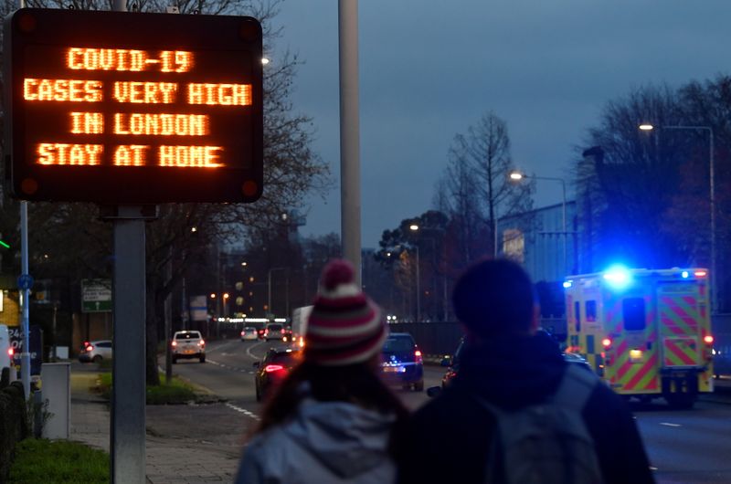 &copy; Reuters. Due pedoni guardano un&apos;ambulanza a Londra