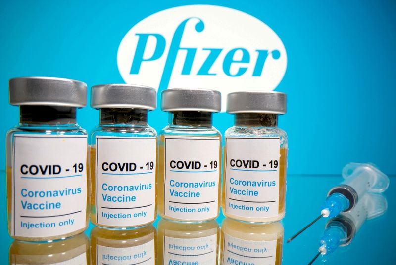 © Reuters. FOTO DE ARCHIVO: Varios viales y una jeringa médica frente al logotipo de Pfizer