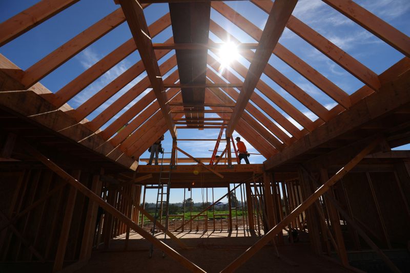 &copy; Reuters. Construction workers build a single family home in San Diego, California