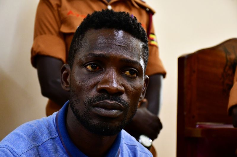 &copy; Reuters. Ugandan presidential candidate Robert Kyagulanyi also known as Bobi Wine sits inside the courtroom in Iganga