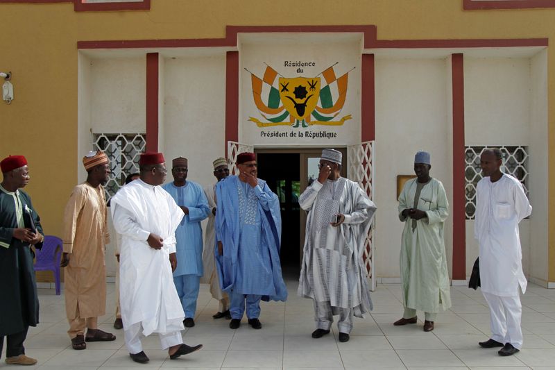 &copy; Reuters. Bazoum stands with members of his delegation at the official presidential residence in Diffa