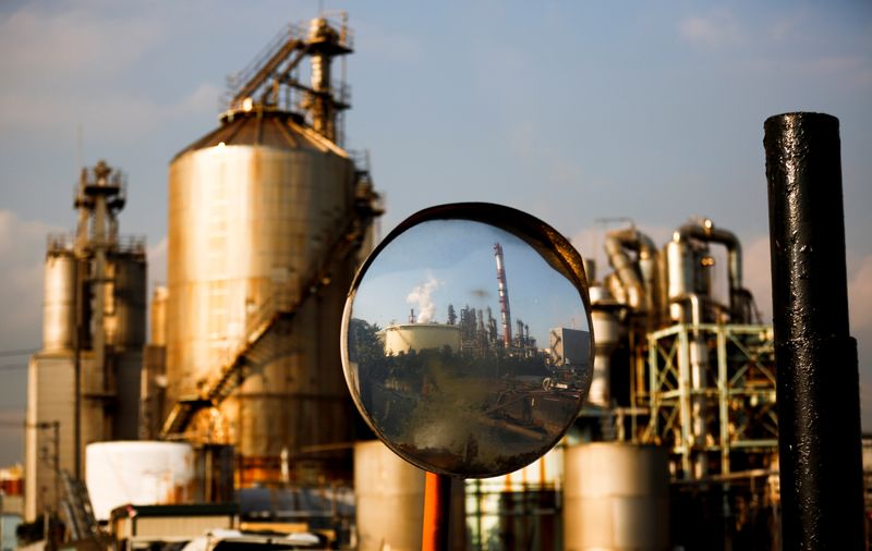 &copy; Reuters. A factory is reflected in a traffic mirror at the Keihin industrial zone in Kawasaki