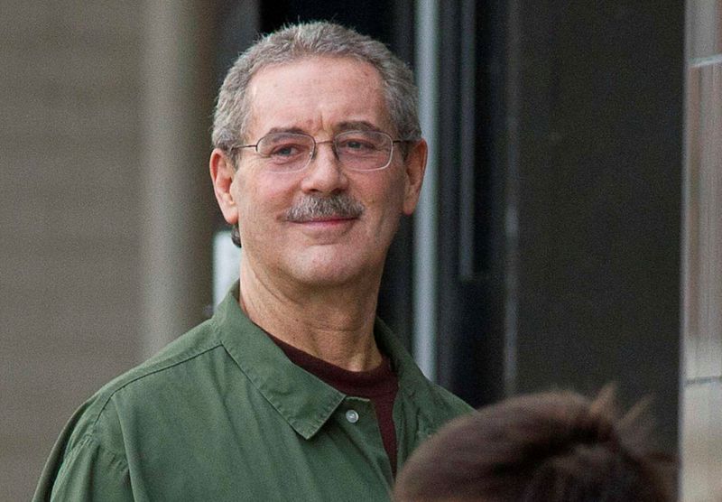 © Reuters. FILE PHOTO: Allen Stanford smiles as he waits to enter the Federal Courthouse where the jury is deliberating in his criminal trial in Houston