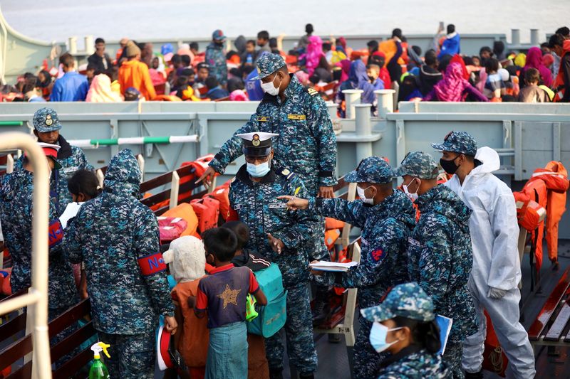 &copy; Reuters. Bangladesh navy personnel check Rohingyas before they board a ship to move to Bhasan Char island in Chattogram, Bangladesh