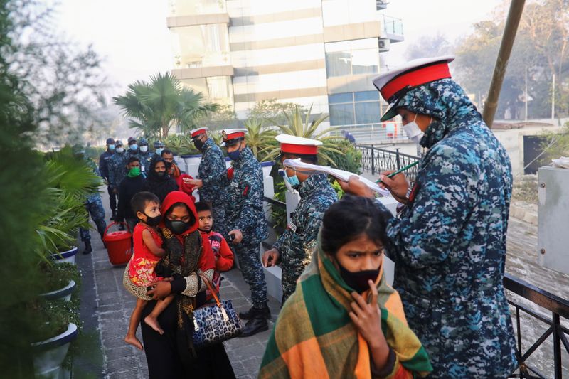 &copy; Reuters. Bangladesh navy personnel check Rohingyas before they board a ship to move to Bhasan Char island in Chattogram, Bangladesh