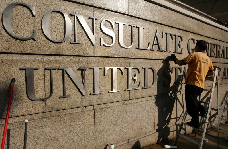 © Reuters. FILE PHOTO: A worker cleans the front wall of the US Consulate General in Hong Kong