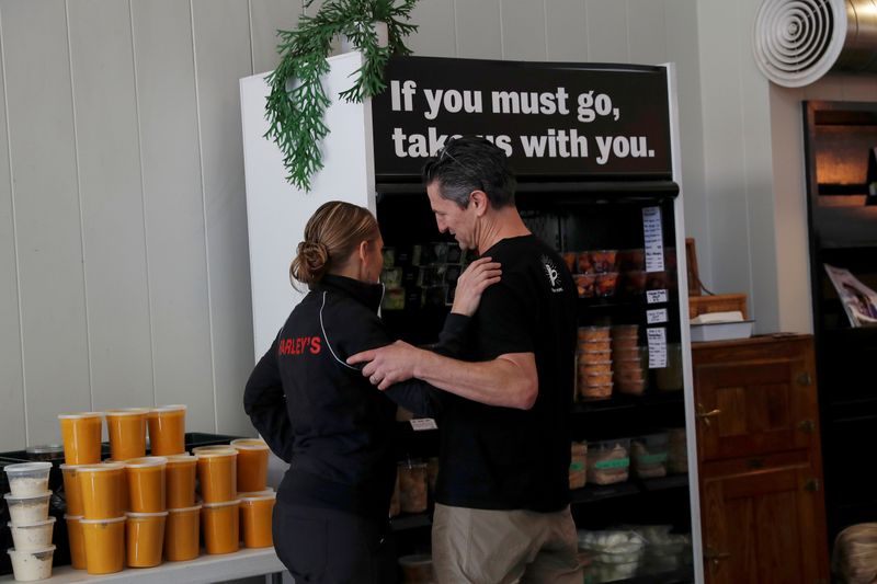 &copy; Reuters. FILE PHOTO: Amy and Chris Hillyard, owners of Farley’s East cafe that closed due to the financial crisis caused by the coronavirus disease (COVID-19), embrace at the cafe in Oakland, California