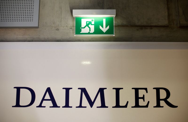 &copy; Reuters. A emergency exit sign is pictured above a logo of German car manufacturer Daimler AG, before the annual news conference in Stuttgart