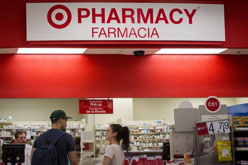 © Reuters. FILE PHOTO: Customers wait in line in the pharmacy department at a Target store in the Brooklyn borough of New York