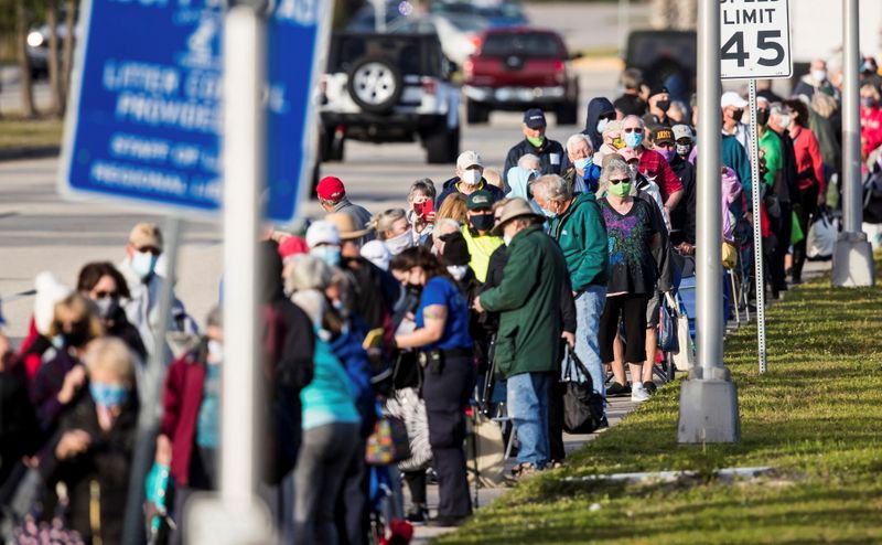 &copy; Reuters. Hundreds wait in line at Lakes Park Regional Library to recieve the COVID-19 vaccine in Fort Myers