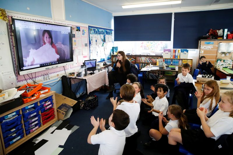 &copy; Reuters. Students at Holne Chase School interact with a class member via the internet
