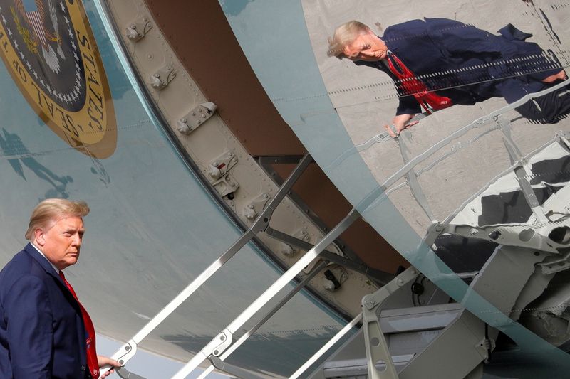 &copy; Reuters. President Trump is seen reflected while boarding Air Force One in West Palm Beach