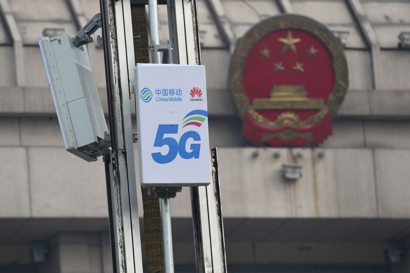 &copy; Reuters. 5G active antenna units with logos of China Mobile and Huawei are seen in front of a National People&apos;s Congress (NPC) conference center in Luoyang, Henan