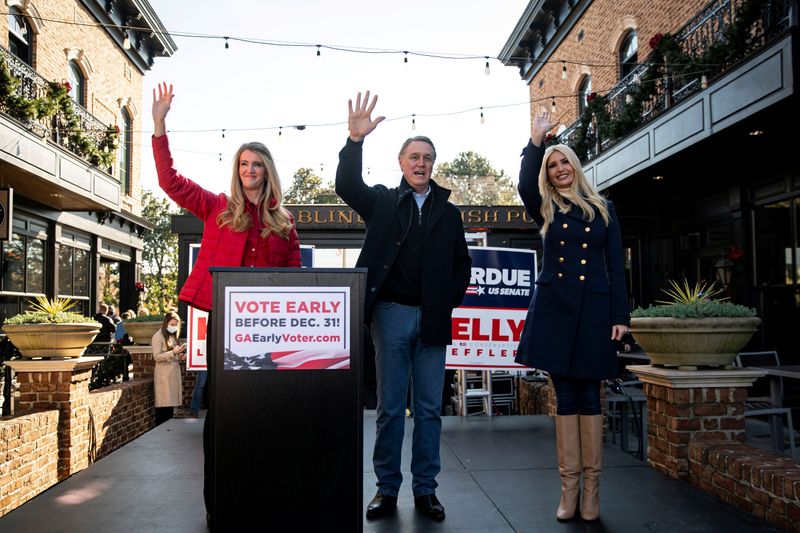 © Reuters. FILE PHOTO: Senator Kelly Loeffler (R-GA), Senator David Perdue (R-GA), and White House senior advisor Ivanka Trump wave during a campaign event in Milton