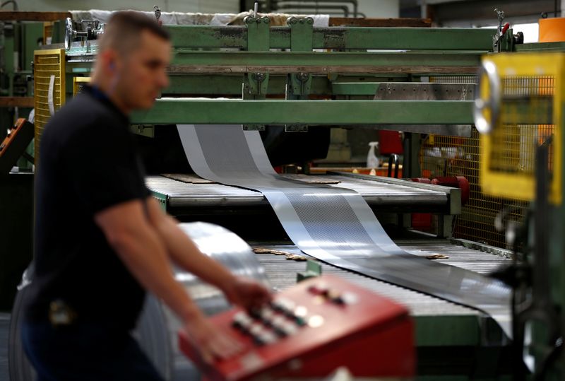 &copy; Reuters. A worker at perforating company Bion uses a machine at the factory in Reading