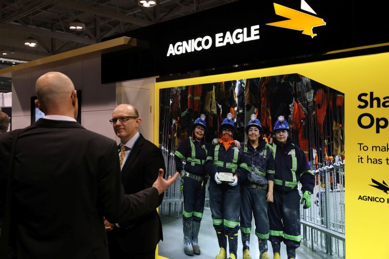 &copy; Reuters. A visitor speaks with a representative of Agnico Eagle Mines Ltd at the PDAC annual conference in Toronto