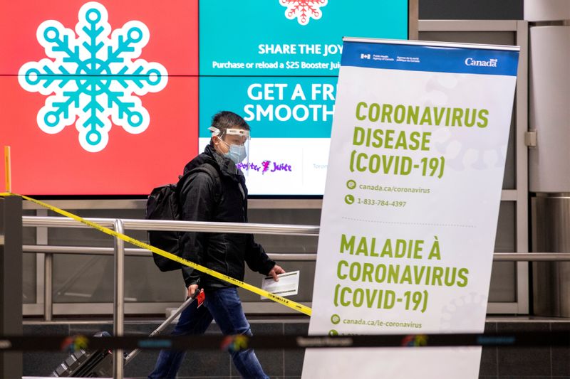 &copy; Reuters. FILE PHOTO: A man walks through terminal 3, amid a spike in coronavirus disease (COVID-19) cases, at Pearson airport