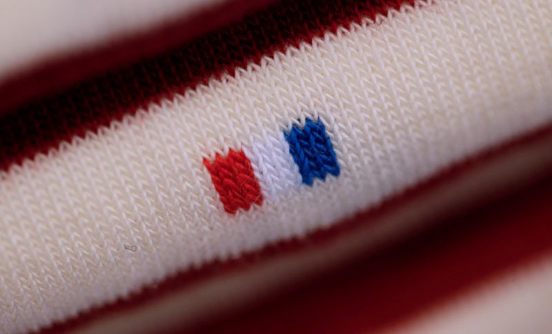 © Reuters. FILE PHOTO: A French flag is seen on a pair of socks displayed at the 