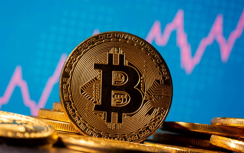 © Reuters. FILE PHOTO: A representation of virtual currency bitcoin is seen in front of a stock graph