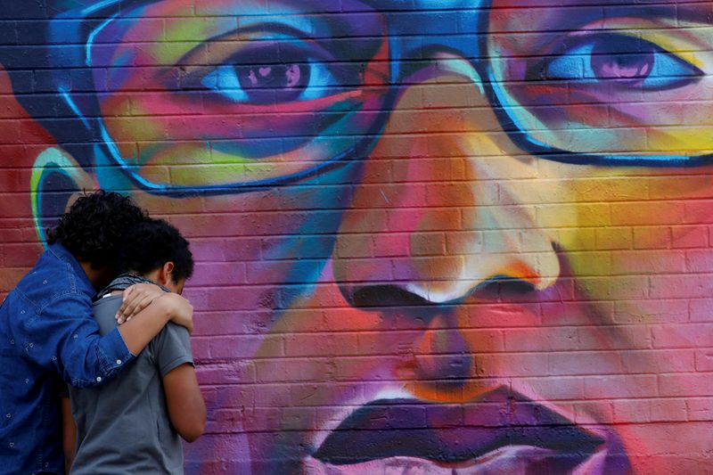 © Reuters. FILE PHOTO: People visit a mural ahead of the one year anniversary of Elijah McClain's death