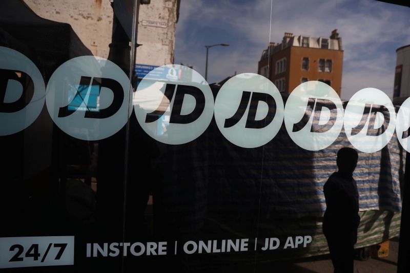 &copy; Reuters. FILE PHOTO: People pass a JD Sports store in London