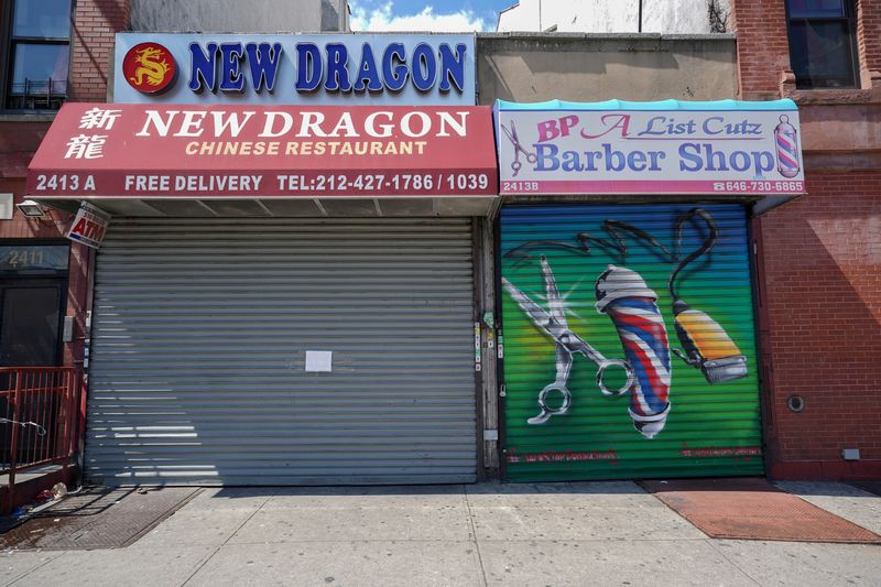 © Reuters. FILE PHOTO: A Chinese restaurant and barber shop in Harlem are closed,
