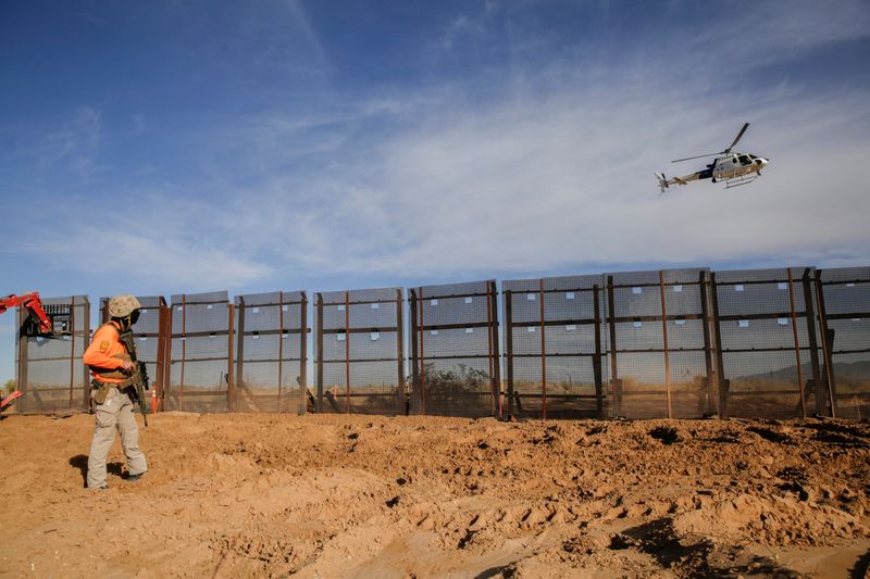 &copy; Reuters. FILE PHOTO: A helicopter of the U.S. Customs and Border Protection (CBP) flies over the construction site where a border fence is being removed, which will be replaced by a new section of the border wall in Sunland Park, New Mexico, U.S., as seen from Ciu