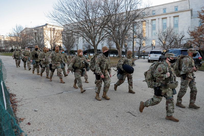 © Reuters. U.S. National Guard members walk near the U.S. Capitol Building on Capitol Hill in Washington