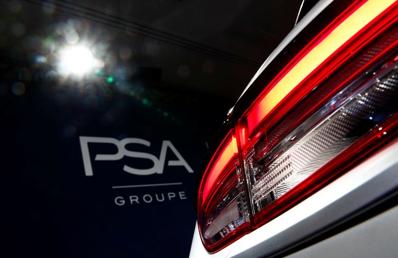 &copy; Reuters. A PSA Group logo is seen behind a car displayed during French carmaker&apos;s news conference as they announce the company&apos;s 2018 results at their headquarters in Rueil-Malmaison