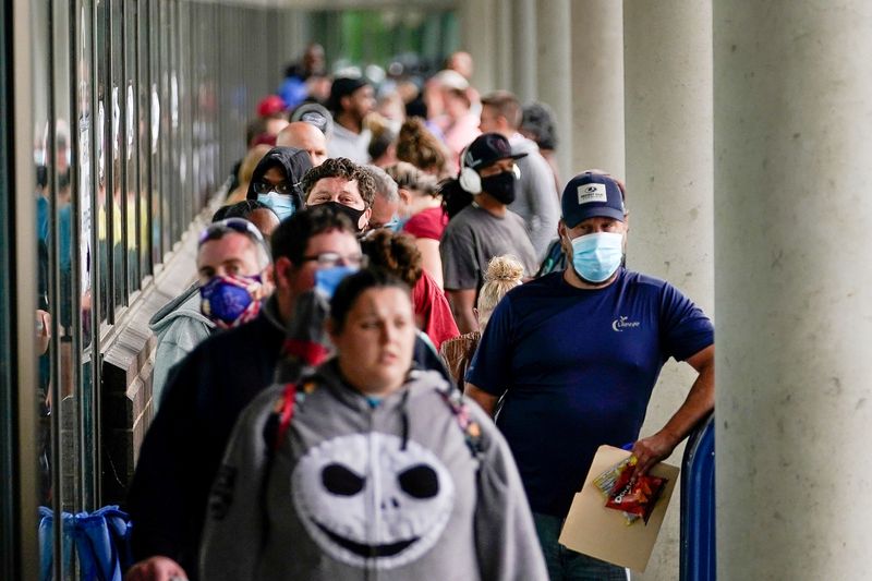 © Reuters. FILE PHOTO: Hundreds of people line up outside a Kentucky Career Center hoping to find assistance with their unemployment claim in Frankfort