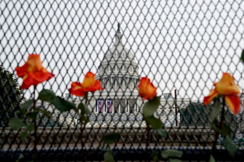 &copy; Reuters. FILE PHOTO: Flowers are placed in security fencing around the U.S. Capitol days after supporters of U.S. President Donald Trump stormed the Capitol in Washington