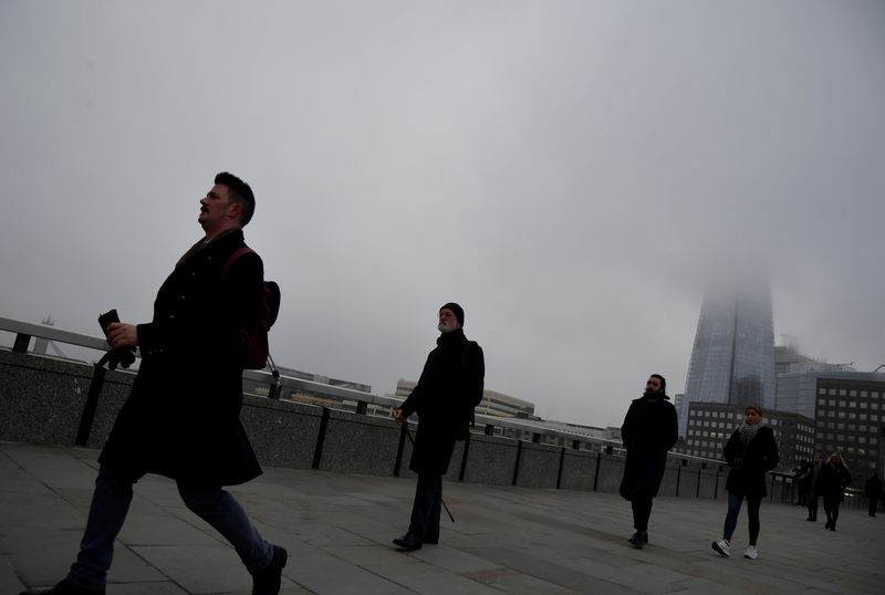 &copy; Reuters. FILE PHOTO: Workers cross London Bridge with The Shard skyscraper seen behind on a foggy morning, in the City of London financial district, amid the spread of the coronavirus disease (COVID-19), London