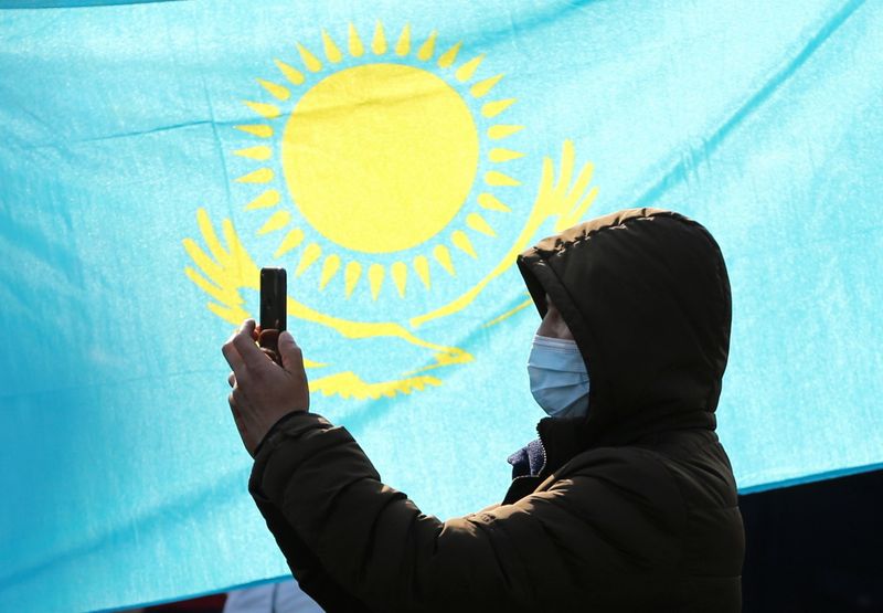 &copy; Reuters. A man stands in front of the Kazakh national flag during a rally against political repression, in Almaty