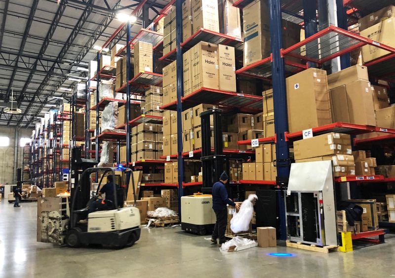 &copy; Reuters. Warehouse workers deal with inventory stacked up to the ceiling at an ABT Electronics Facility in Glenview