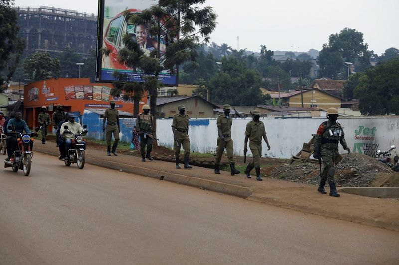 © Reuters. Ugandan security forces walk in a formation in Kampala