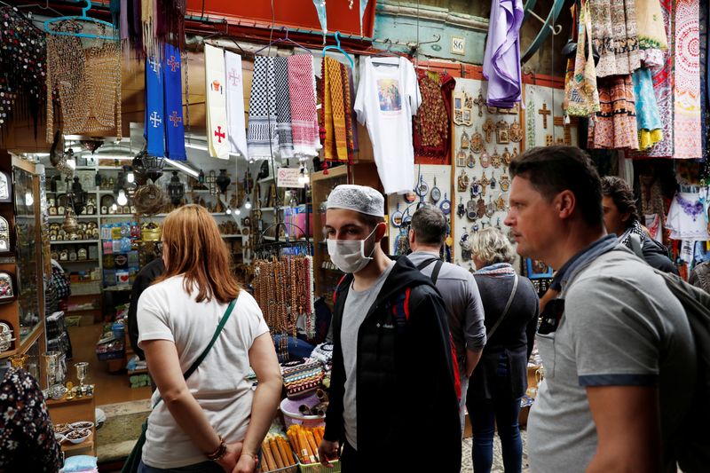 &copy; Reuters. A  man wears a face mask for protection releted to the coronavirus as he walks in Jerusalem&apos;s Old City