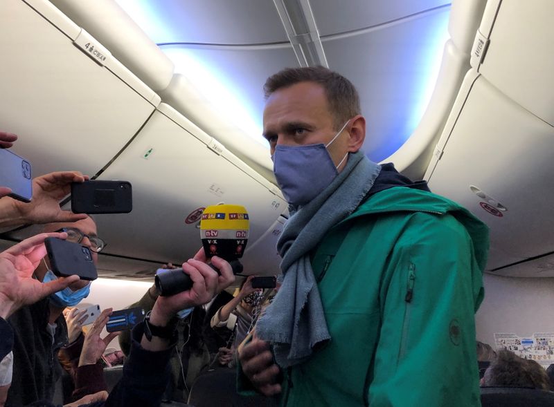 &copy; Reuters. Russian opposition leader Alexei Navalny is seen on board a plane before the departure for Moscow at an airport in Berlin