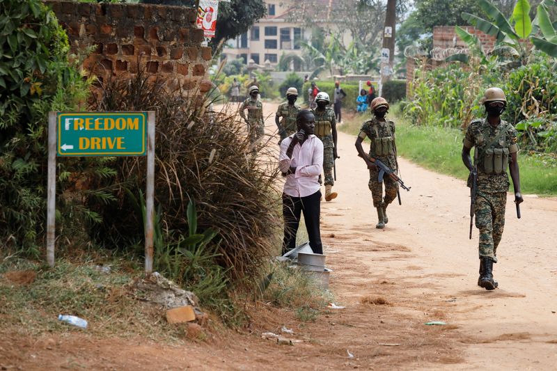 © Reuters. Ugandan soldiers patrol near the house of Ugandan opposition presidential candidate Robert Kyagulanyi in Kampala