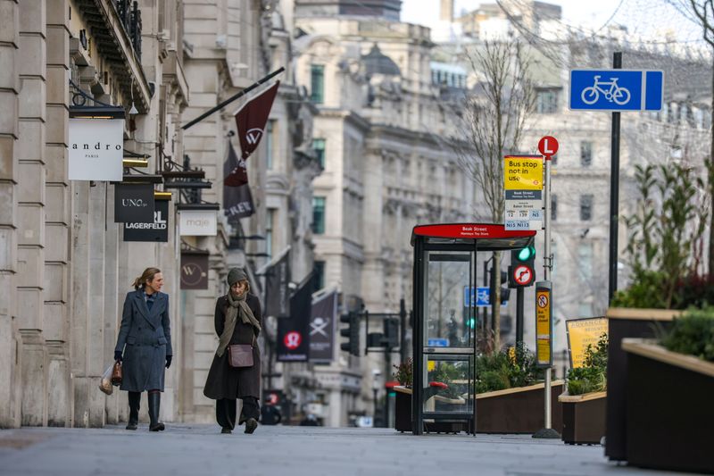 &copy; Reuters. Two women walk down Regent Street in London