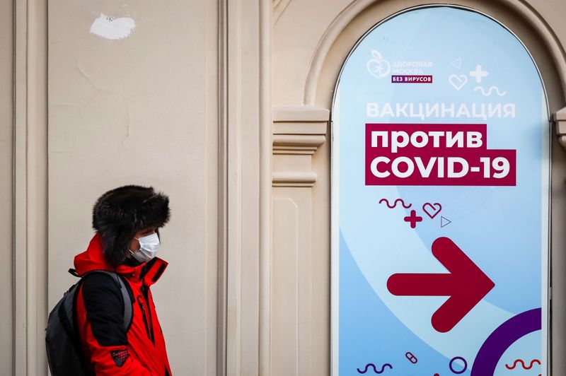 &copy; Reuters. A man walks past a sign outside a vaccination centre in the State Department Store, GUM, in Moscow