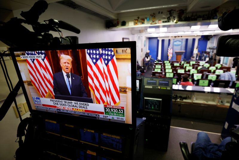 © Reuters. Trump makes remarks on TV monitor from White House Briefing Room during his last day in office, in Washington