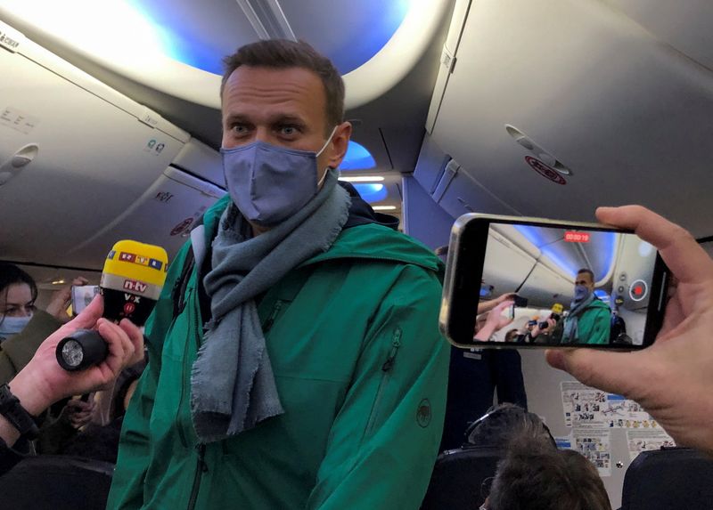 © Reuters. Russian opposition leader Alexei Navalny is seen on board a plane before the departure for Moscow at an airport in Berlin