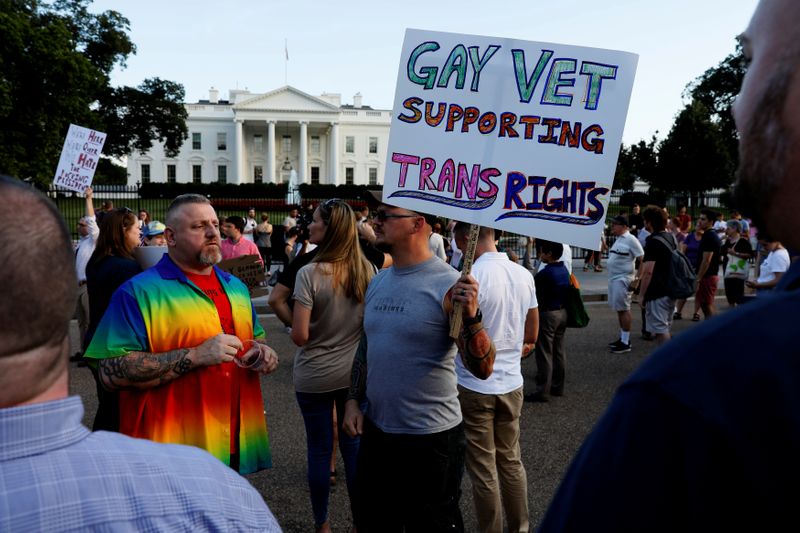 &copy; Reuters. Demonstrators gather to protest Trump&apos;s announcement that he plans to reinstate a ban on transgender individuals from serving in the military, at the White House in Washington
