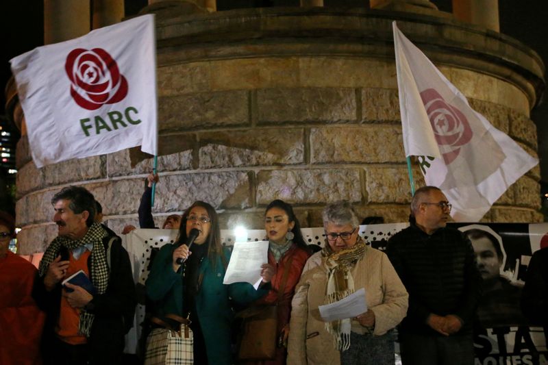 &copy; Reuters. FILE PHOTO: Supporters of the Revolutionary Alternative Force of the Common attend a vigil in memory of former FARC guerrillas killed after the peace agreement made with the government in Bogota