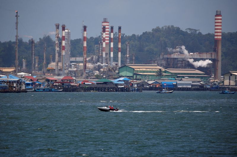 &copy; Reuters. People sit on a boat driving through Balikpapan bay in East Kalimantan province