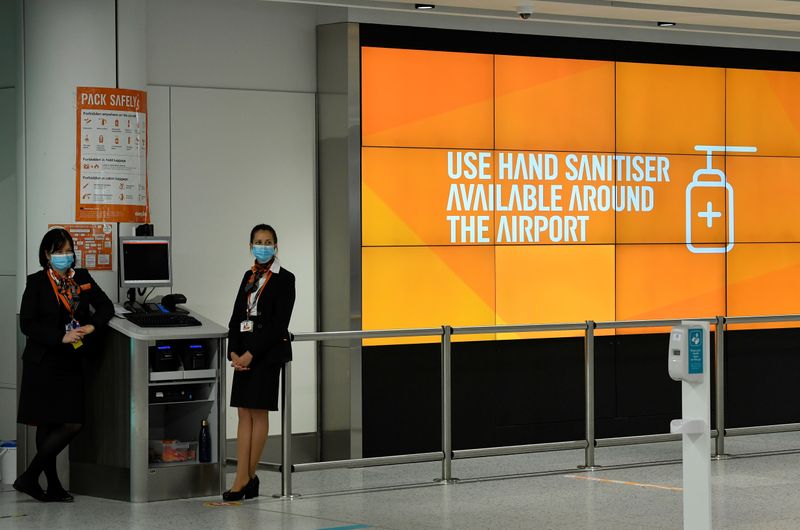 &copy; Reuters. Staff are seen at an Easy Jet checking area at Gatwick Airport, in Gatwick