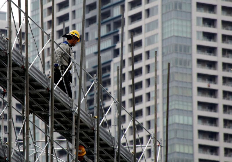&copy; Reuters. FILE PHOTO: A worker is seen at the construction site of Athletes&apos; Village for Tokyo 2020 Olympic games, which will serve as residential apartments after the Olympics in Tokyo