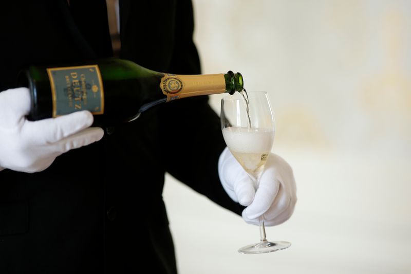 &copy; Reuters. An employee serves a glass of Champagne during the traditional wine harvest at the Champagne house Deutz in Ay