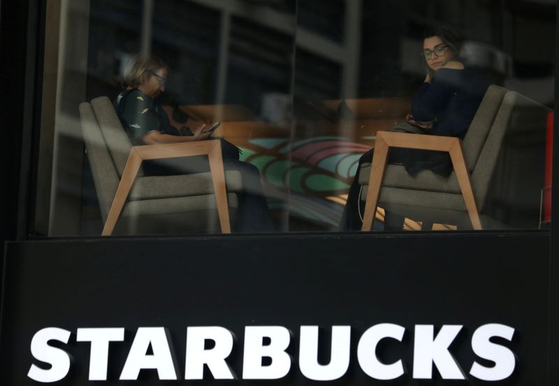 &copy; Reuters. FILE PHOTO: Customers sit inside a Starbucks coffee shop in Rio de Janeiro