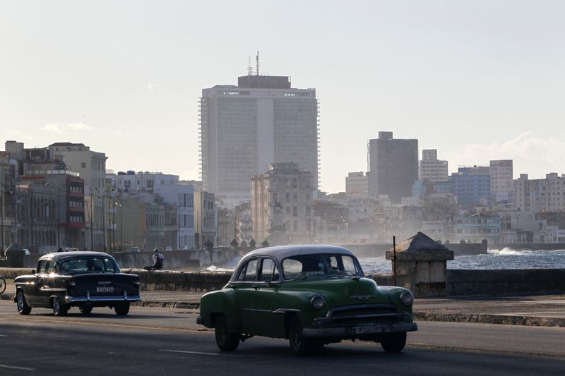 &copy; Reuters. Vintage cars drive on the seafront boulevard El Malecon in Havana